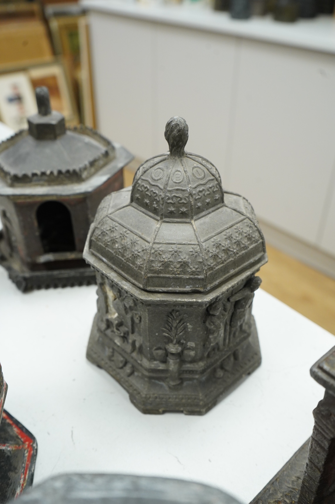 A collection of nine early 19th century lead tobacco boxes and a cover, tallest 20cm